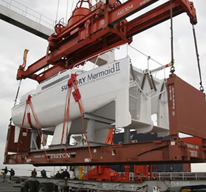 A large crane loaded the ship onto a container ship.